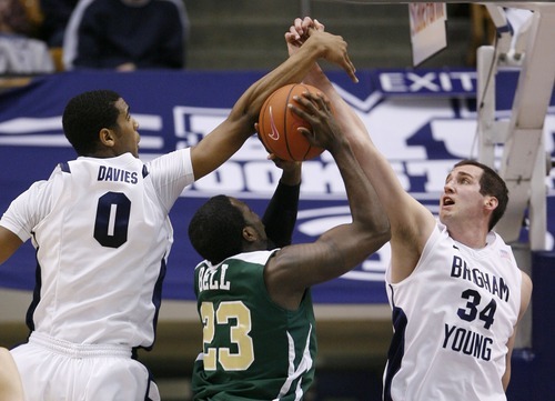 Steve Griffin  |  The Salt Lake Tribune
 
BYU's Brandon Davies and Noah Hartsock team up to block the shot of CSU's Will Bell during first half action in the BYU versus CSU men's basketball game at the Marriott Center in Provo, Utah Wednesday, February 23, 2011.