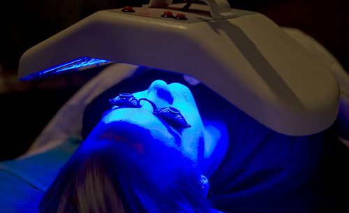 Al Hartmann   |  The Salt Lake Tribune 
Aesthetician student Sarah Olsen receives blue LED light therapy at the Cameo School of Essential Beauty in Murray.