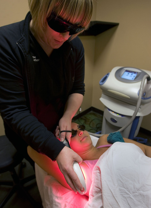 Al Hartmann   |  The Salt Lake Tribune 
Aesthetician student Sharlee Lattta, bottom, gets an underarm hair removal laser treatment from Cameo School of Essential Beauty Spa director and instructor Adraine Baxter. A Utah lawmaker is pushing a bill to require aestheticians to be supervised by a licensed physician.