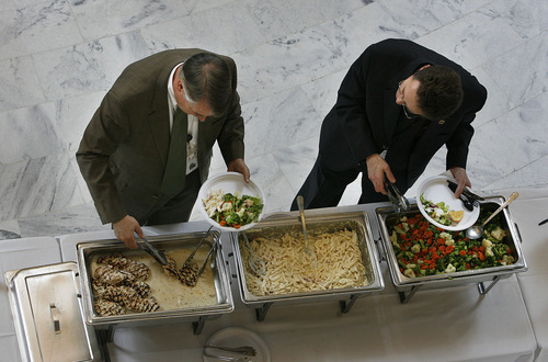SCOTT SOMMERDORF  |  The Salt Lake Tribune
The Utah Realtors Association catered a lunch for lawmakers Friday in the Capitol Rotunda.Sen. John Valentine, R-Orem, left, and Rep. Jim Nielson, R-Bountiful, help themselves during Friday's event. Nielson paid for his lunch.