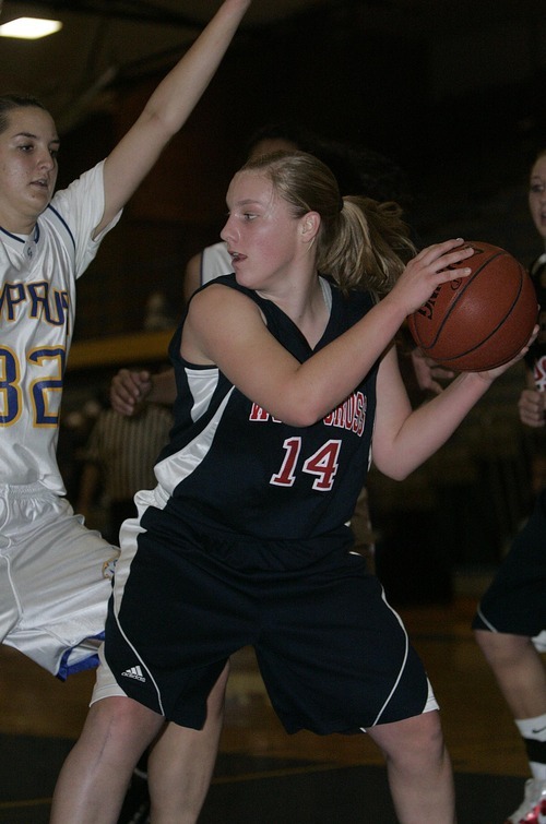 Djamila Grossman  |  The Salt Lake Tribune

Woods Cross High's Cami Horrocks, 14, is blocked by Cyprus High School's Erica Scott, 32, during a game in Magna, Utah, Wednesday, Dec. 22, 2010. Cyprus won the game.