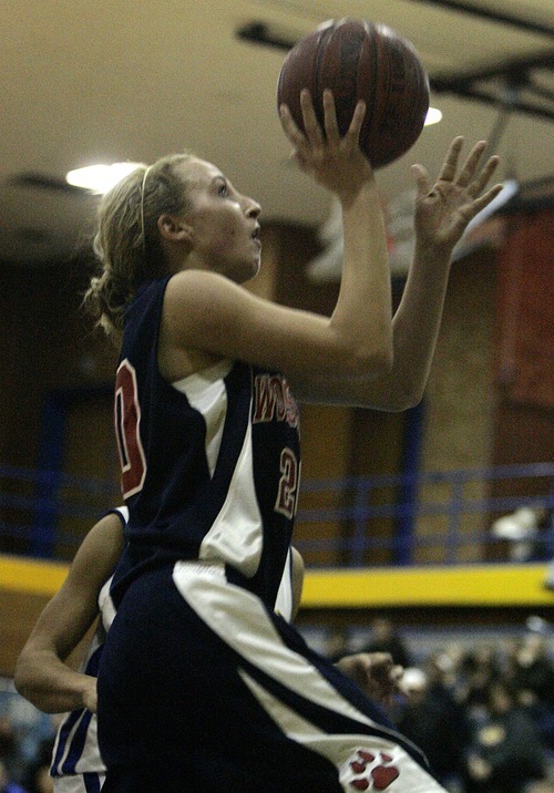 Djamila Grossman  |  The Salt Lake Tribune

Woods Cross High's Natalie Parson, 20, scores during a game against Cyprus High School in Magna, Utah, Wednesday, Dec. 22, 2010. Cyprus won the game.