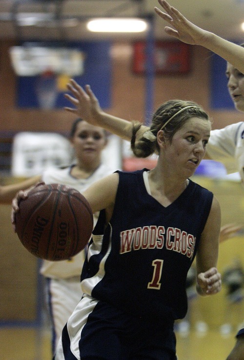 Djamila Grossman  |  The Salt Lake Tribune

Woods Cross High's Erica Anderson, 1, drives the ball toward the basket during a game against Cyprus High School in Magna, Utah, Wednesday, Dec. 22, 2010. Cyprus won the game.