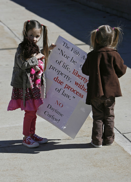 Francisco Kjolseth  |  The Salt Lake Tribune

Leah Lund, 4, left, and her sister Clara, 2, join other home- schooled kids outside of the Provo City Center on Tuesday  to protest a proposal to crack down on truants.