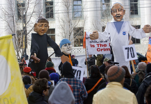 Al Hartmann   |  The Salt Lake Tribune 
Puppets of a federal judge, left, Tim DeChristopher, center, and NASA climatologist James Hansen are used in a skit during a rally to support DeChristopher across the street from the federal couthouse where his trial is set to begin Monday.