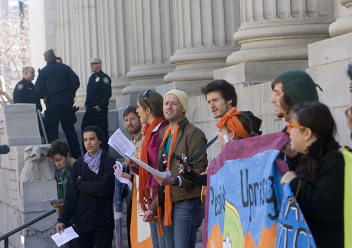 Al Hartmann   |  The Salt Lake Tribune 
Supporters of  Tim DeChristopher sing and rally on the steps of the Frank Moss Federal Court in Salt Lake City on Tuesday, March 1 for the first day of trial. The eco-activist is on trial for disrupting an oil and gas lease auction.