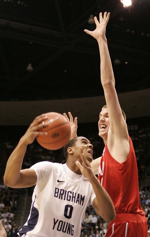 Trent Nelson  |  The Salt Lake Tribune
BYU's Brandon Davies shoots with Utah's David Foster defending during a game in Provo on Feb. 12, 2011. Davies, the starting center, has been dismissed from BYU's basketball team for violating the school's honor code.