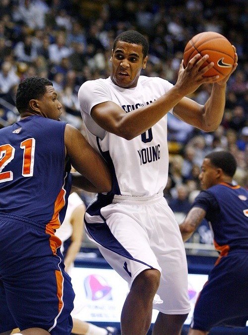 Djamila Grossman  |  The Salt Lake Tribune

Brigham Young University's Brandon Davies pushes past Fresno Pacific University's Kendall Holmes during a game Jan. 1, 2011. 
Davies, who dismissed from the team on March 1 because of an honor code violation, plans to play next season.
