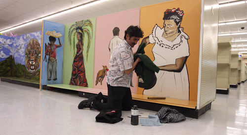 Leah Hogsten  |  The Salt Lake Tribune
 Artist and art instructor Jimmy Lucero in front of his and his colleagues' work Wednesday, March 2, 2011. Latino artists have painted a series of murals in the new Viva Market.
