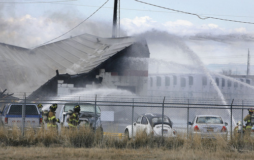 Scott Sommerdorf  |  The Salt Lake Tribune
Fire crews douse blaze at building housing The Cartel and Clear Sky Biofuels in Clearfield Friday. The fire also destroyed an adjacent building. The fire was sparked by an explosion at the biofuels business.