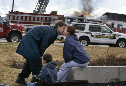 Scott Sommerdorf  |  The Salt Lake Tribune
Gary Clark, a co-owner of Clear Sky Biofuels in Clearfield, kisses his wife, Lisa, after narrowly escaping fire that destroyed his business Friday. The Clarks and their 4-year-old son, Corbin, watched the flames from a playground across the street from the business.