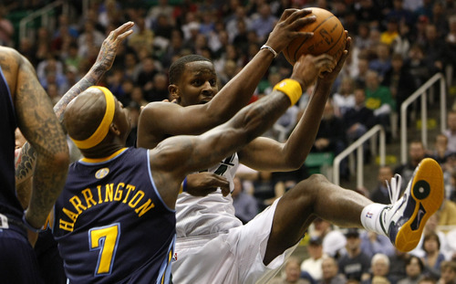 Photo by Chris Detrick | The Salt Lake Tribune 
Utah Jazz small forward C.J. Miles (34) grabs a rebound past Denver Nuggets power forward Al Harrington (7) during the second half of the game at EnergySolutions Arena Thursday March 3, 2011.  Denver won the game 103-101.