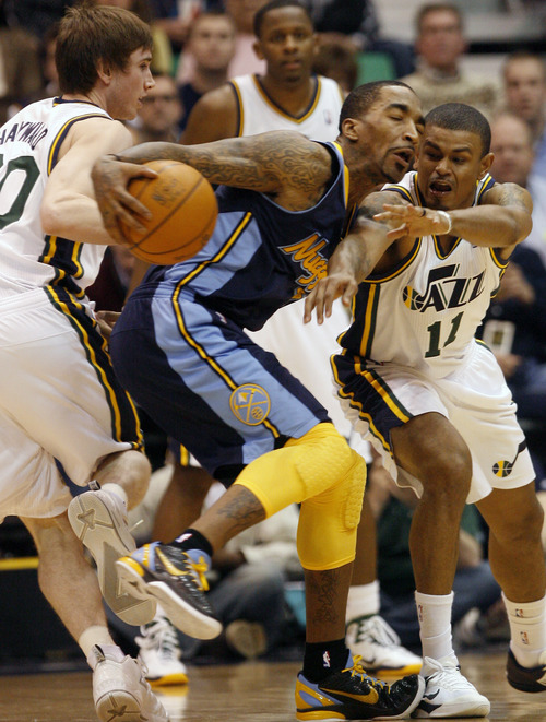 Photo by Chris Detrick | The Salt Lake Tribune 
Utah Jazz small forward Gordon Hayward (20) and Utah Jazz point guard Earl Watson (11) guard Denver Nuggets shooting guard J.R. Smith (5) during the second half of the game at EnergySolutions Arena Thursday March 3, 2011.  Denver won the game 103-101.