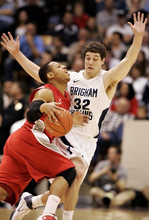 Djamila Grossman  |  The Salt Lake Tribune

BYU's Jimmer Fredette blocks New Mexico's Dairese Gary in the second half of the game on Wednesday. BYU lost the game, 82-64.