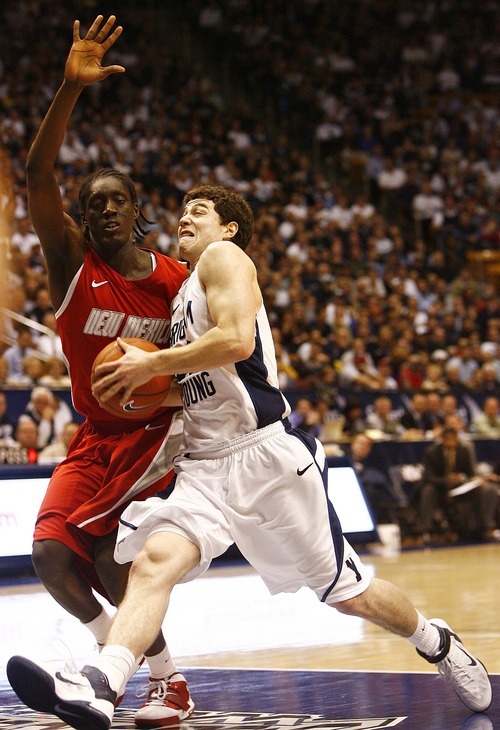 Djamila Grossman  |  The Salt Lake Tribune

Brigham Young University plays New Mexico in Provo, Utah, on Wednesday, March 2, 2011. BYU's Jimmer Fredette (32) is blocked by New Mexico's Tony Snell (21) in the second half of the game. BYU lost the game.