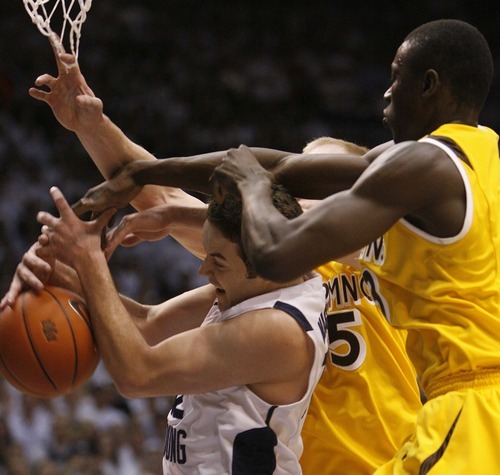 Trent Nelson  |  The Salt Lake Tribune
BYU's Logan Magnusson fights for a rebound as BYU hosts Wyoming, college basketball in Provo, Utah, Saturday, March 5, 2011. Wyoming's Djibril Thiam at right.