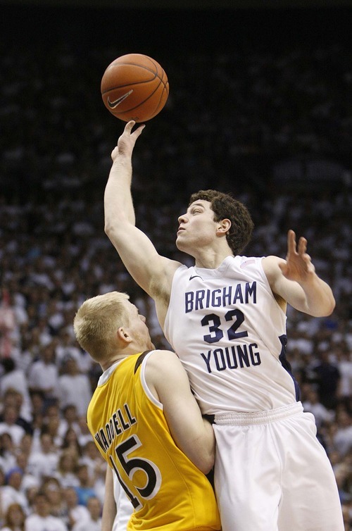 Trent Nelson  |  The Salt Lake Tribune
BYU's Jimmer Fredette shoots over Wyoming's Adam Waddell as BYU hosts Wyoming, college basketball in Provo, Utah, Saturday, March 5, 2011.