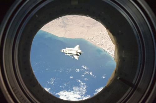 In this image provided by NASA the space shuttle Discovery is seen from the International Space Station as the two orbital spacecraft accomplish their relative separation on March 7, 2011 after an aggregate of 12 astronauts and cosmonauts worked together for over a week. The area below is the southwestern coast of Morocco in the northern Atlantic. During a post undocking fly-around, the crew members aboard the two spacecraft collected a series of photos of each other's vehicle.  Discovery is on the verge of ending its nearly 27-year flying career. Landing is set for Wednesday.  (AP Photo/NASA)