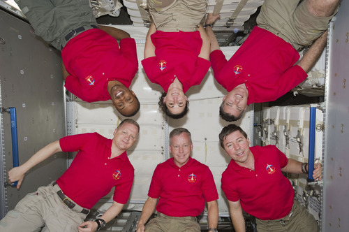 In this March 4, 2011 photo provided by NASA, inside the newly installed Permanent Multipurpose Module (PMM) on the International Space Station are the six crew members of the STS-133 crew who've been spending busy days with the six astronauts and cosmonauts of Expedition 26, not shown. At bottom, from the left, are astronauts Eric Boe, Steve Lindsay and Michael Barratt. On top are astronauts Alvin Drew, Nicole Stott and Steve Bowen (AP Photo/NASA)