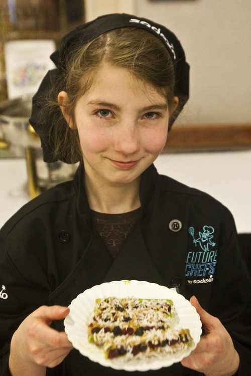 Chris Detrick | The Salt Lake Tribune 
Sarah Burris, a fourth-grader at Pleasant Green Elementary, shows her Bugs on a Log snack during the first Future Chefs of America competition at the Granite Education Center. Sarah won a 