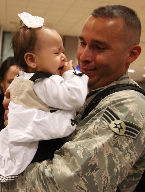 Leah Hogsten  |  The Salt Lake Tribune
Senior Airman Geiber Rea greets his daughter, Amelie, 5 months, for the first time.