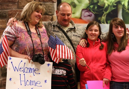 Leah Hogsten  |  The Salt Lake Tribune
McKenzie Carroll, 10, jokingly covers the face of her brother Jay, 6, during a family photo with her mother, Gidget; father, Staff Sgt. Jay Carroll; and sister, Jaycie, 13; after their father returned on Wednesday.
