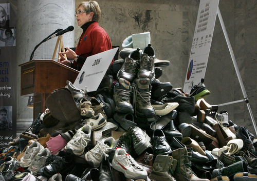 Scott Sommerdorf  |  The Salt Lake Tribune
Rep. Becky Edwards, R-North Salt Lake, speaks at an Autism Council of Utah event in the Capitol rotunda, Thursday, March 10, 2011. In the foreground are 980 shoes that represent one tenth of the number of children with autism in the state. The figure is based on a 2006 estimate that totaled 9,800 kids with autism in the state. Rep. Edwards was instrumental in getting the Autism Council a specialized Utah license plate this year.