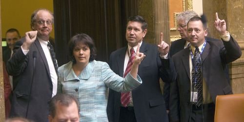 AL HARTMANN  |  The Salt Lake Tribune  
Reps. John Mathis, left, House Speaker Becky Lockhart, Val Peterson, and Paul Ray slip into the back of the House chamber to vote yes on SB73, which would prohibit schools from considering seniority in laying off teachers.  It passed both in both houses on Wednesday and went to the governor.