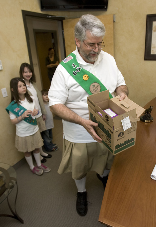 Al Hartmann   |  The Salt Lake Tribune 
Want to see what happens when two executives at 1-800 CONTACTS make a friendly bet about selling 200 boxes of Girl Scout cookies? The loser of the bet - Jay Magure, vice president of government relations, is dresses up in a regulation Girl Scout uniform with a skirt and delivers 200 boxes of cookies on Friday, March 11 at 1 p.m. at 1-800 CONTACTS headquarters with his two granddaughters who are Girl Scouts. Jay agreed to the bet because he didn't think Joe Zeidner, general counsel at 1-800, could possibly sell 200 boxes --let alone 100 boxes. Joe sent out the word at 1-800 CONTACTS and the boxes were sold in four hours.