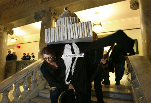 Scott Sommerdorf  |  The Salt Lake Tribune
Protestors of HB477 walk a large puppet representing government down the steps away from the House of Representatives at the Utah State Capitol, Thursday, March 10, 2011.