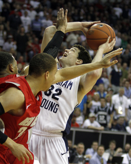Rick Egan  | Salt Lake Tribune

BYU guard Jimmer Fredette (32) shoots over a New Mexico double team, in the Mountain West Conference Championships, BYU vs. New Mexico,  in Las Vegas, Friday, March 11, 2011.  Fredette had 33 points for the Cougars in the first half.