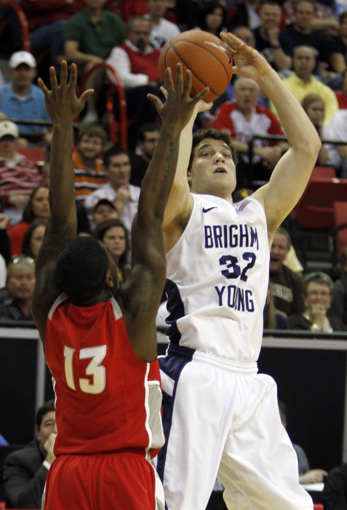 Rick Egan  | Salt Lake Tribune

BYU guard Jimmer Fredette shoots over New Mexico guard Jamal Fenton, in the Mountain West Conference Championships, BYU vs. New Mexico, in Las Vegas, Friday, March 11, 2011.  Fredette had 33 points for the Cougars in the first half.