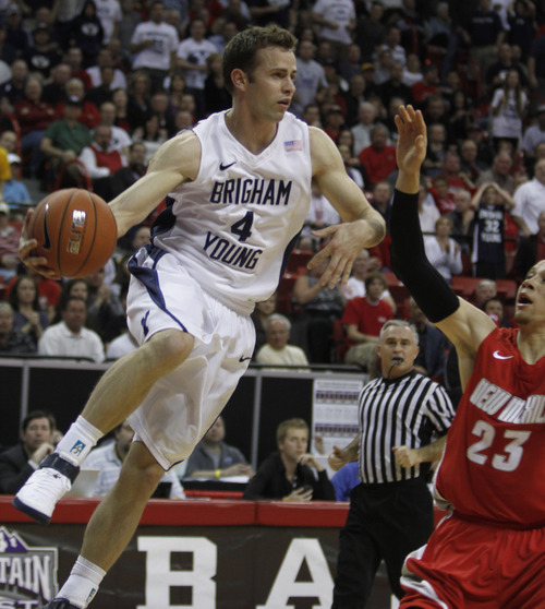 Rick Egan  | Salt Lake Tribune

BYU guard Jackson Emery (4) passes the ball off, in the Mountain West Conference Championships, BYU vs. New Mexico,  in Las Vegas, Friday, March 11, 2011.  Fredette had 33 points for the Cougars in the first half.