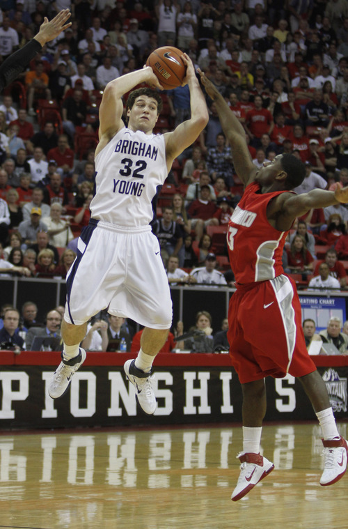 Rick Egan  | Salt Lake Tribune

BYU guard Jimmer Fredette (32) shoots for the Cougars, as New Mexico guard Curtis Dennis (3) defends, in the Mountain West Conference Championships, BYU vs. New Mexico,  in Las Vegas, Friday, March 11, 2011.  Fredette had 52 points for the Cougars in their 87-76 win over the Lobos.