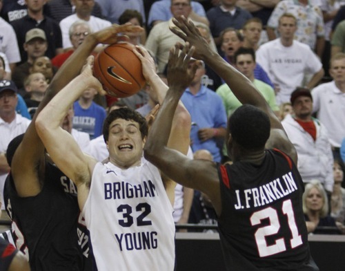 Rick Egan   |  The Salt Lake Tribune

BYU guard Jimmer Fredette (32) takes a shot at the end of the first half as he is double teamed by San Diego State guard Chase Tapley (22) and San Diego State guard Jamaal Franklin (21) in the Mountain West Championship game, BYU vs. San Diego State, in Las Vegas, Saturday, March 12, 2011. The shot was good, but was called back after the officials reviewed the play.