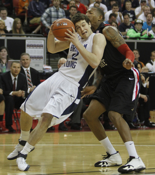 Rick Egan   |  The Salt Lake Tribune

BYU guard Jimmer Fredette (32) is fouled by San Diego State forward Billy White (32), as he goes up for a shot,  
in the Mountain West Championship game, BYU vs. San Diego State, in Las Vegas, Saturday, March 12, 2011