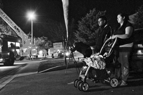 Mario E. Ruiz  |  Special to The Salt Lake Tribune

Boulders residents Anavel Dominguez and Jose Cortez watch firefighters put out a smoldering apartment building Monday night. A fire killed two people at The Boulders apartment complex in Provo on Monday.