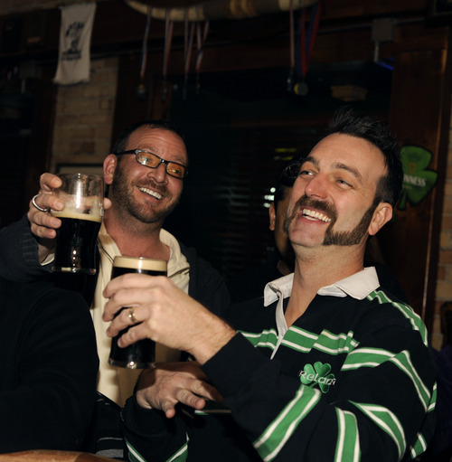 Sarah A. Miller  |  Tribune file photo
Piper Down bar owner David Morris socializes with friends and bar patrons, including Brenton Basda, left, at Piper Down on  March 4. Piper Down is an Irish-style bar.