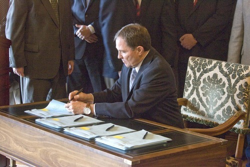 PAUL FRAUGHTON  |  The Salt Lake Tribune 
With religious, community, business and government leaders behind him, Utah Gov. Gary Herbert on Tuesday signed into law immigration  bills passed in this year's legislative session, including a controversial guest-worker program (HB116) and an enforcement bill (HB497).