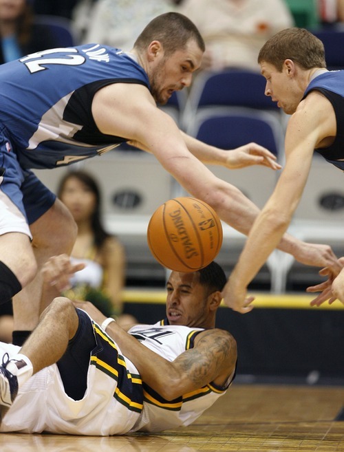 Steve Griffin  |  The Salt Lake Tribune
 
Utah Jazz guard Devon Harris, bottom, tries to come up with the ball after striping Minnesota's Luke Ridnour, right,  of the ball during a game at the EnergySolutions Arena  in Salt Lake City on Wednesday, March 16, 2011. Kevin Love of the Timberwolves is at right.