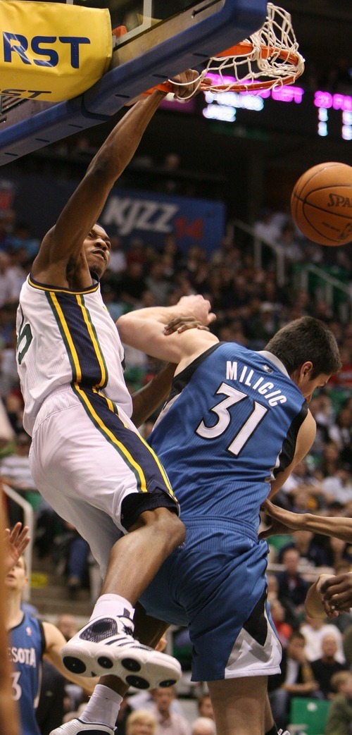 Steve Griffin  |  The Salt Lake Tribune
 
 Utah Jazz forward Derrick Favors throws down a monster dunk over Minnesota's Darko Milicic during a game against the Timberwolves at EnergySolutions Arena  in Salt Lake City on Wednesday, March 16, 2011.