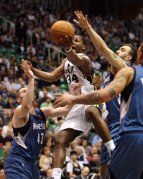 Steve Griffin  |  The Salt Lake Tribune
 
 Utah Jazz guard C.J. Miles lifts a shot over the Minnesota defense during a game against the Timberwolves at EnergySolutions Arena  in Salt Lake City on Wednesday, March 16, 2011.