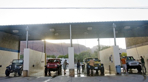 Djamila Grossman  |  The Salt Lake Tribune

Four Jeeps are being cleaned in a car wash in Moab on Saturday, Oct. 2, 2010.