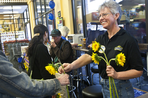 Chris Detrick | The Salt Lake Tribune 
Floor Manager Patty Rayman gives out sunflowers to customers at Sunflower Farmers Market at 656 E. 200 South in Salt Lake City on Wednesday March 16, 2011.