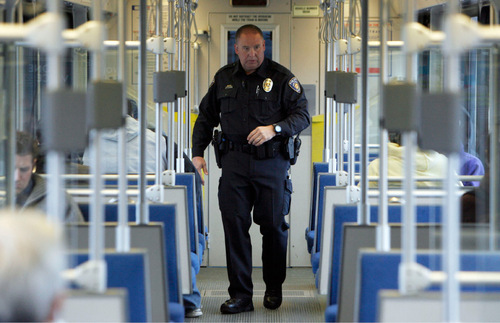 FRANCISCO KJOLSETH  |  Tribune File Photo
Utah Transit Authority officer Lloyd Davis, a former Layton City officer of 17-years who became a UTA officer following his retirement in June of 2008, rides the TRAX line on the way to the University of Utah in this 2010 photo. UTA is in talks with Salt Lake County Sheriff Jim Winder about a possible merger for transit law enforcement.