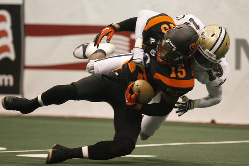 Photo by Chris Detrick | The Salt Lake Tribune 
Utah Blaze's Alvance Robinson (15) is tackled by Erick McIntosh (19) during the game at EnergySolutions Arena Thursday March 17, 2011.