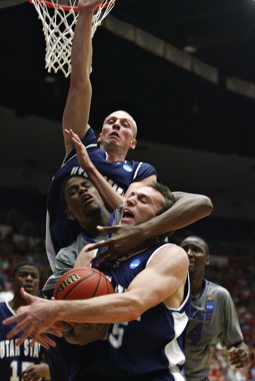 Djamila Grossman  |  The Salt Lake Tribune

Utah State University's Nate Bendall (35) and Brady Jardine (22) defend the ball against Kansas State's Jordan Henriquez-Roberts (21) in the first half of the second round of the NCAA tournament at the University of Arizona's McKale Center in Tucson, Ariz., on Thursday, March 17, 2011.