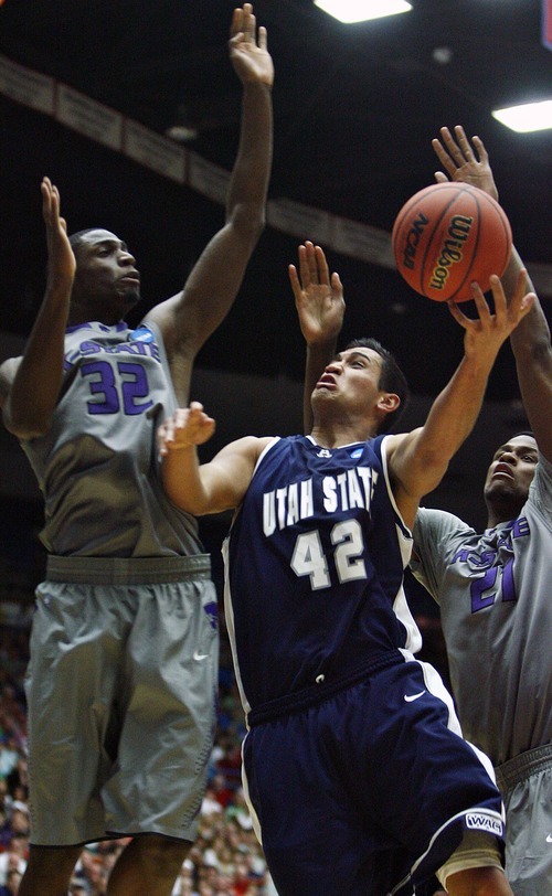 Djamila Grossman  |  The Salt Lake Tribune

Utah State University's Tai Wesley (42) gets blocked under the basket by Kansas State's Jamar Samuels (32) and Jordan Henriquez-Roberts (21) in the first half of the second round of the NCAA tournament at the University of Arizona's McKale Center in Tucson, Ariz., on Thursday, March 17, 2011.