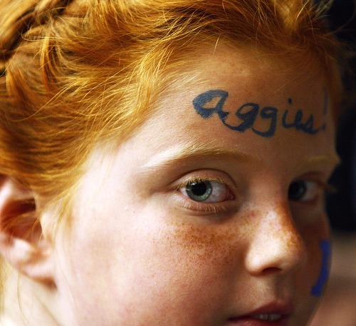 Djamila Grossman  |  The Salt Lake Tribune

Utah State University fan Isabelle Toller, 9, painted her face before the second round of the NCAA tournament against Kansas at the University of Arizona's McKale Center in Tucson, Ariz., on Thursday, March 17, 2011.