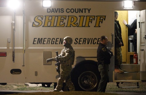 Rick Egan  |  The Salt Lake Tribune

Armed officers at the scene of a shooting on Main Street in Kaysville on Saturday, March 19, 2011. Joseph Allen Nance was booked into jail Sunday on suspicion of murder in the shooting death of his father, Gregory Allen Nance.